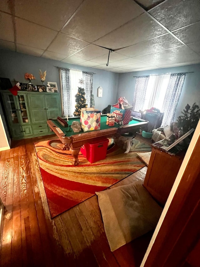 interior space with a drop ceiling, wood finished floors, and a wealth of natural light