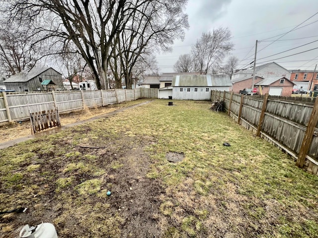 view of yard with a fenced backyard and a residential view