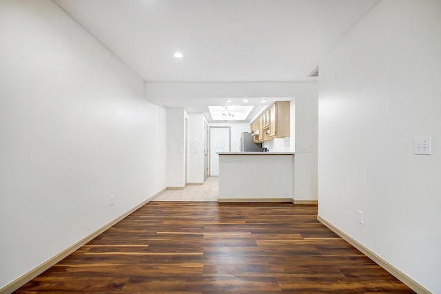 spare room with recessed lighting, dark wood finished floors, and baseboards