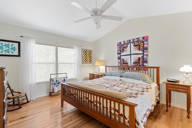 bedroom with lofted ceiling, a ceiling fan, baseboards, and wood finished floors