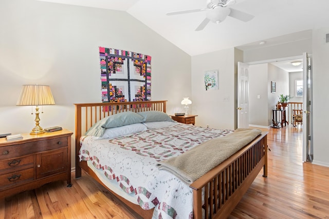 bedroom with a ceiling fan, visible vents, vaulted ceiling, baseboards, and light wood finished floors