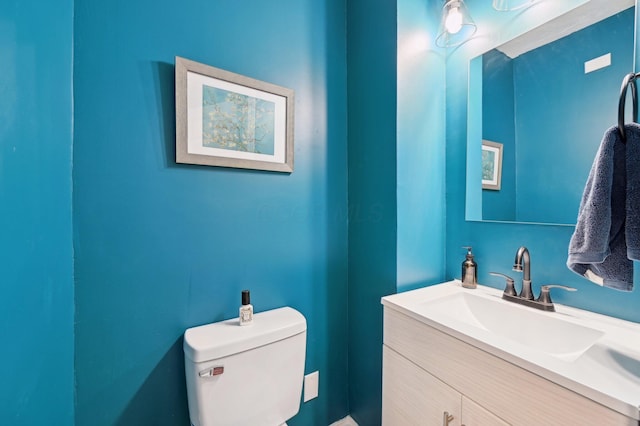 bathroom featuring toilet and vanity