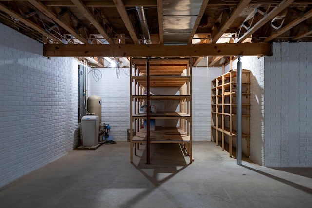 unfinished below grade area with brick wall