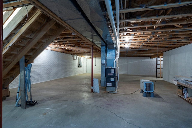 unfinished basement featuring heating unit