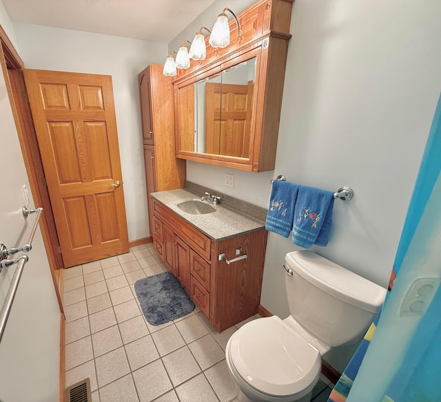 bathroom featuring vanity, tile patterned floors, toilet, and visible vents
