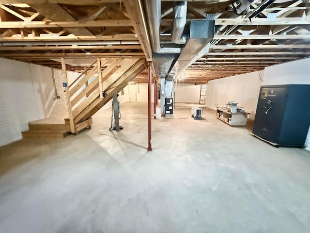unfinished basement featuring heating unit