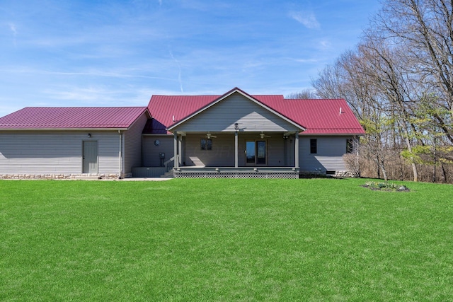 view of front of home with metal roof, covered porch, and a front lawn