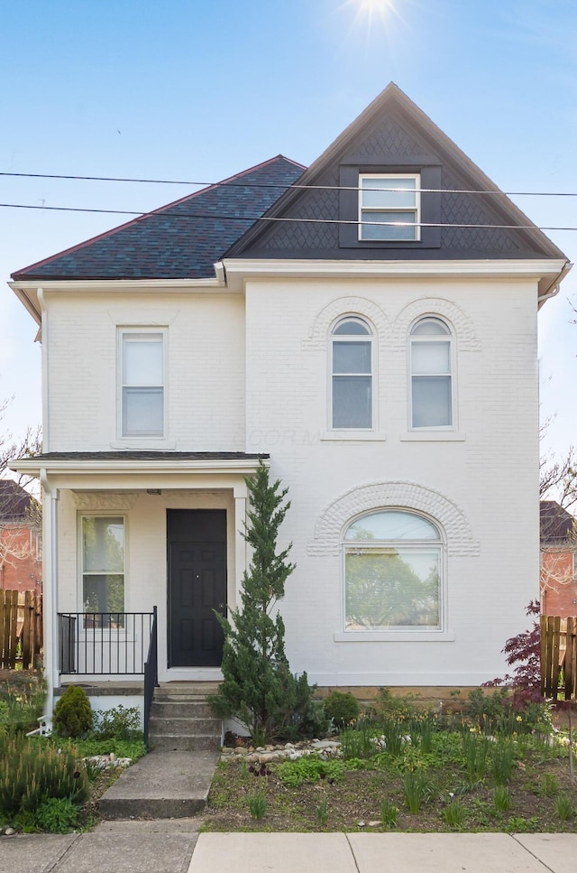 view of front of property featuring a porch and brick siding