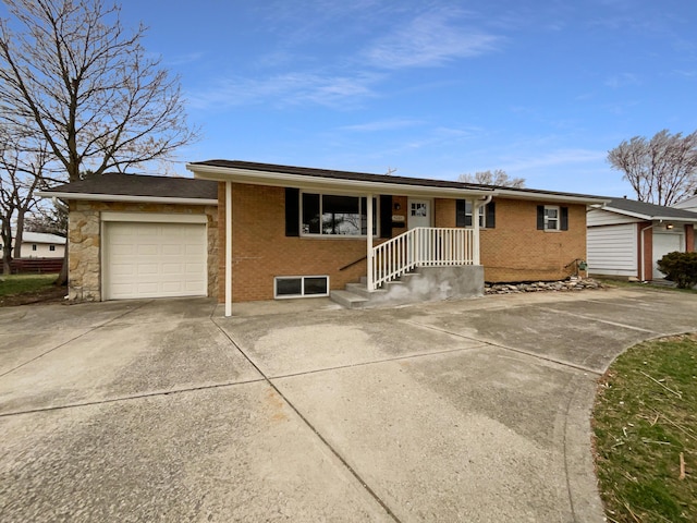 single story home with concrete driveway, brick siding, and an attached garage