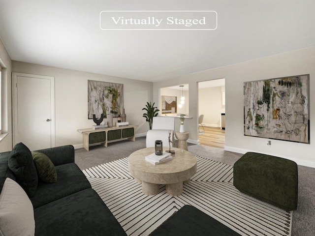 carpeted living area featuring baseboards