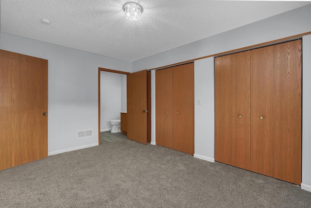 unfurnished bedroom featuring carpet floors, baseboards, visible vents, and a textured ceiling