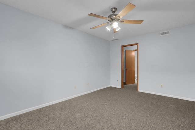 carpeted spare room with a textured ceiling, a ceiling fan, visible vents, and baseboards