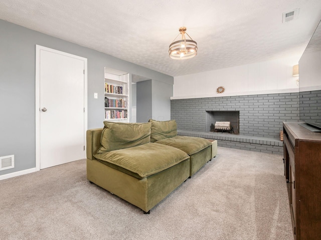 living area featuring carpet floors, a fireplace, visible vents, and a textured ceiling