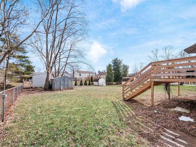 view of yard featuring an outbuilding, a storage unit, and a fenced backyard