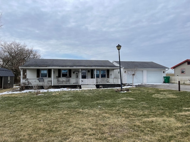 single story home featuring a porch, a front yard, driveway, and an attached garage