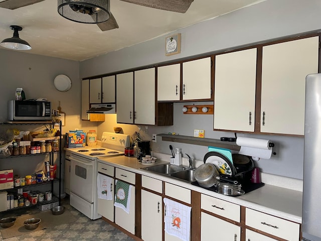 kitchen featuring light floors, stainless steel appliances, light countertops, white cabinets, and under cabinet range hood