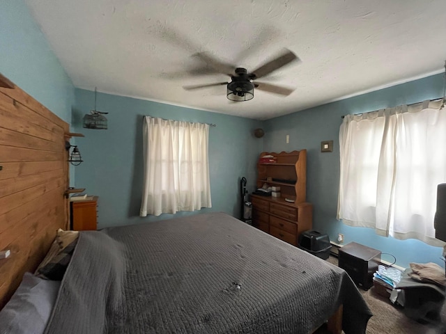 bedroom featuring a textured ceiling and a ceiling fan