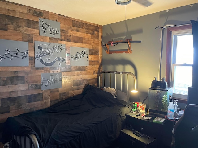 bedroom featuring wooden walls