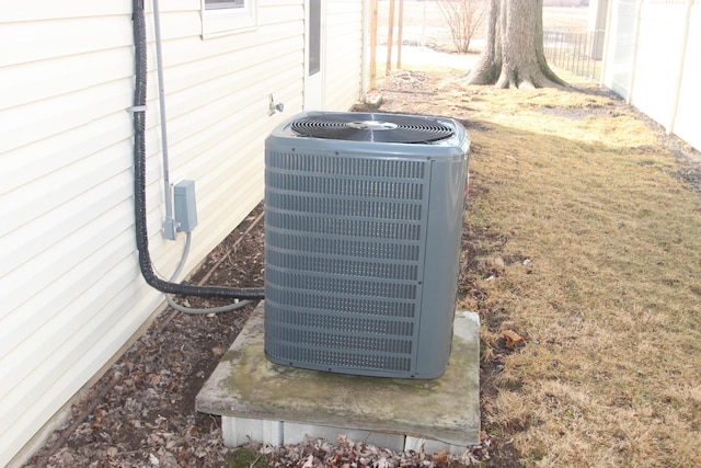 details featuring central air condition unit and fence