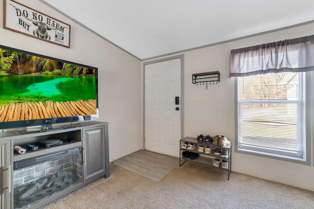 carpeted foyer entrance with lofted ceiling