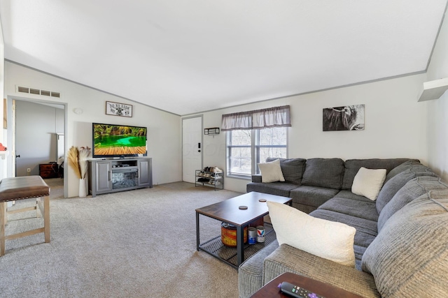 carpeted living room featuring visible vents and lofted ceiling