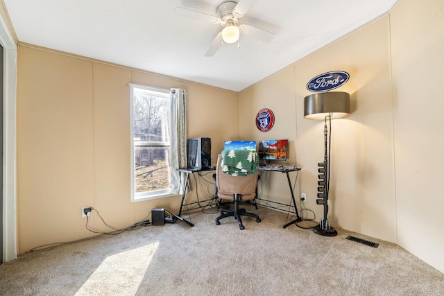 carpeted office featuring visible vents and a ceiling fan