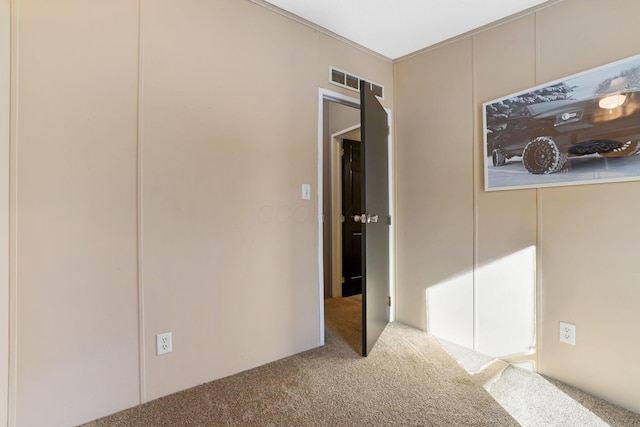 unfurnished bedroom with visible vents and carpet