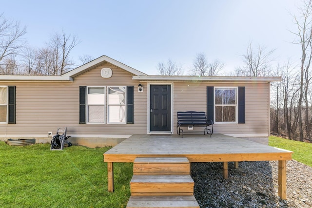 exterior space with a deck and a lawn