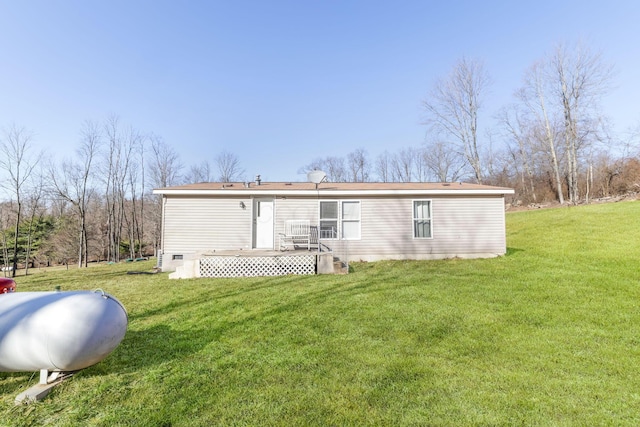 rear view of house featuring crawl space, a lawn, and a wooden deck