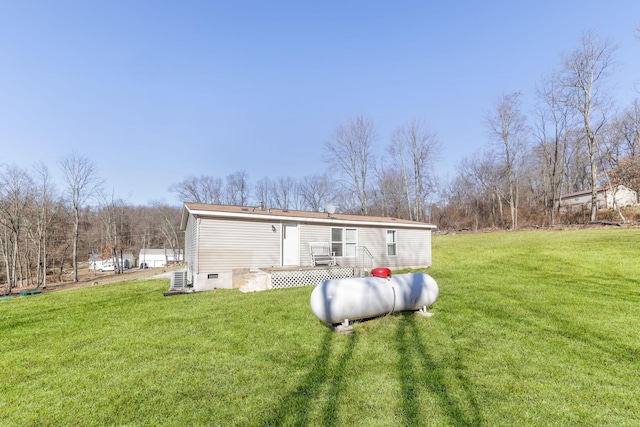 back of house featuring crawl space, a deck, and a yard