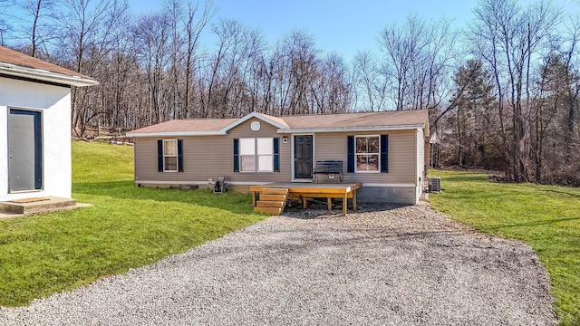 manufactured / mobile home featuring a front yard and cooling unit