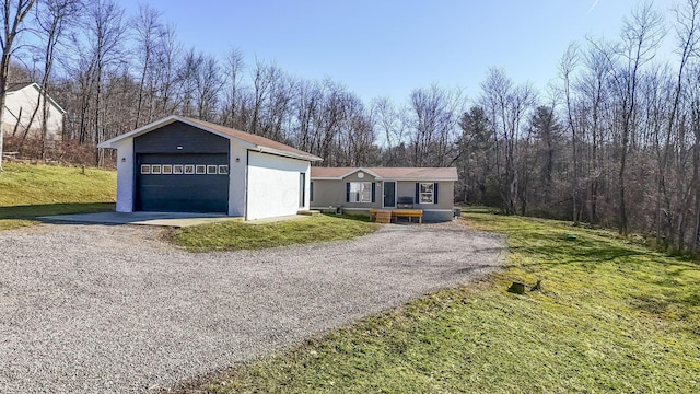 view of front of property with a garage, an outdoor structure, and a front yard