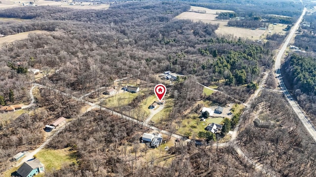 bird's eye view with a wooded view