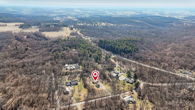 birds eye view of property with a wooded view