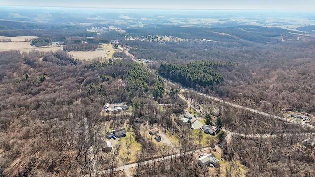 bird's eye view featuring a wooded view