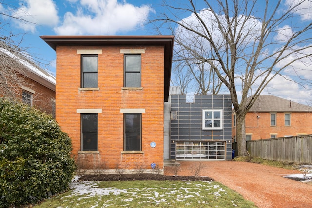 back of property with brick siding and fence