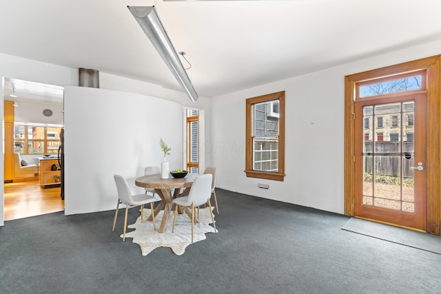 dining room with dark carpet