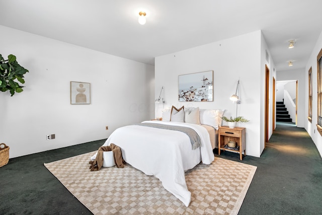 bedroom with dark colored carpet