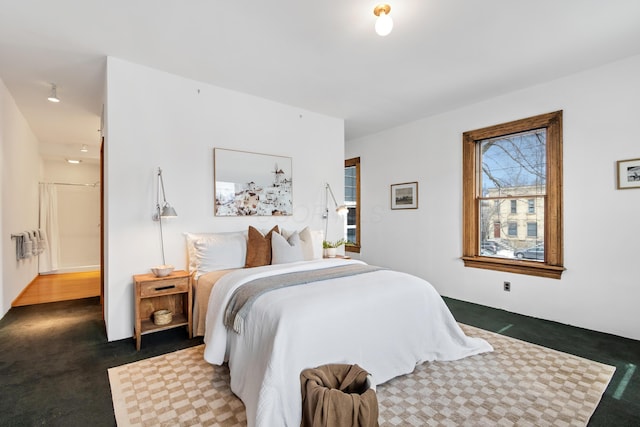 bedroom featuring dark carpet