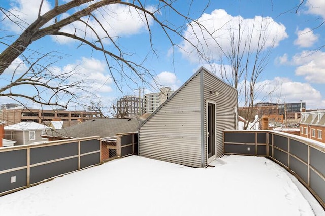 snow covered structure with fence