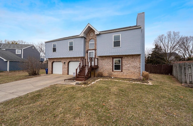 bi-level home featuring fence, a front lawn, and brick siding