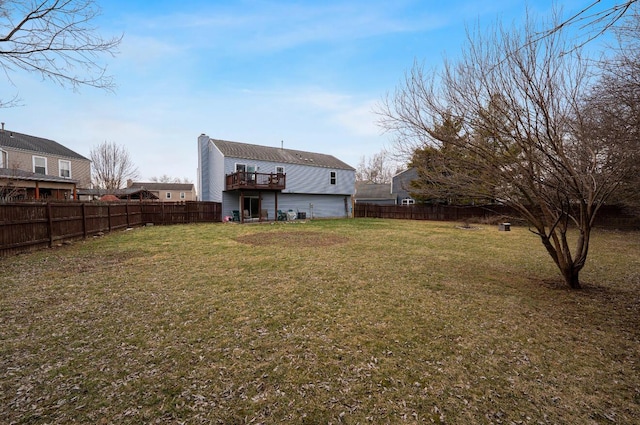 back of property with a fenced backyard and a lawn