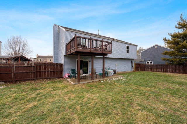 back of house with a fenced backyard, a yard, and a wooden deck