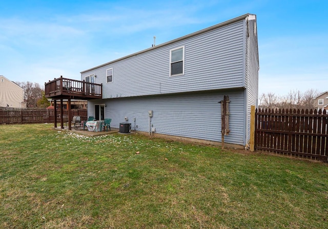 rear view of house featuring a yard, central air condition unit, a patio area, a fenced backyard, and a wooden deck