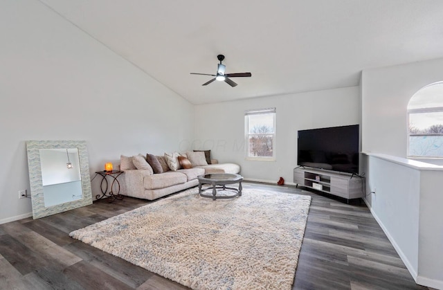 living area featuring lofted ceiling, dark wood-style floors, baseboards, and a ceiling fan