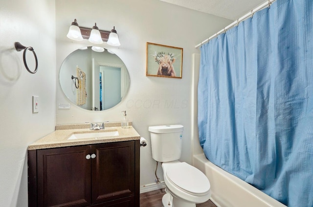 bathroom with wood finished floors, shower / bath combo, vanity, and toilet