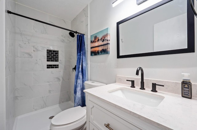 full bath featuring toilet, a stall shower, and vanity