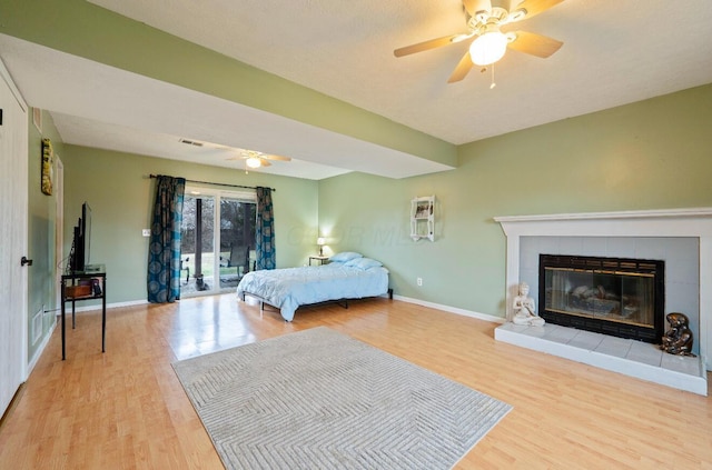 bedroom featuring access to exterior, light wood-type flooring, visible vents, and baseboards