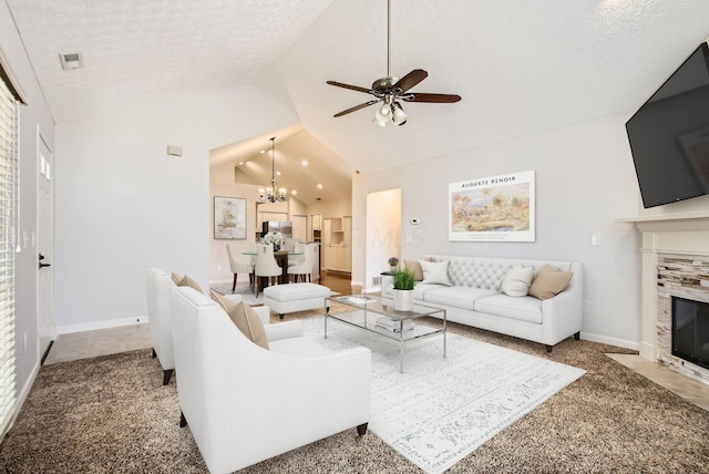 carpeted living room featuring lofted ceiling, a textured ceiling, ceiling fan with notable chandelier, a premium fireplace, and visible vents