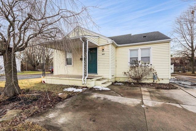 bungalow-style house with a shingled roof